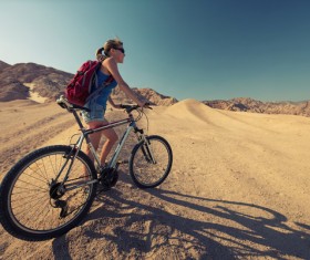 Woman riding mountain bike trip Stock Photo 01