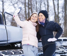 Woman using smartphone for selfie in winter Stock Photo