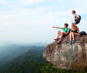 Young climber sitting on the mountain top Stock Photo