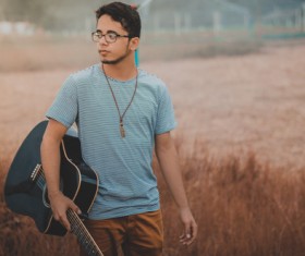 Young man holding guitar Stock Photo