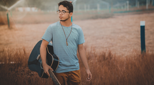Young man holding guitar Stock Photo