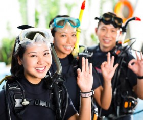 Young people dressed in diving suits Stock Photo