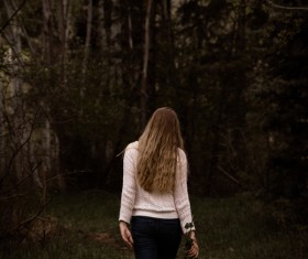 blonde woman walking on pathway Stock Photo