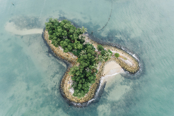 green island on calm beach Stock Photo