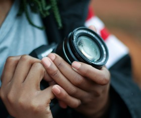 holding camera man Stock Photo