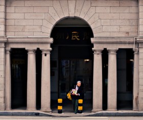 man walking in front of classical building Stock Photo