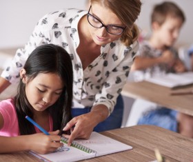 teacher instructing pupil to spell Stock Photo