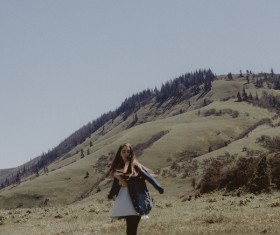 young woman posing on hill Stock Photo