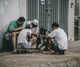 Asian men playing chess on pavement Stock Photo
