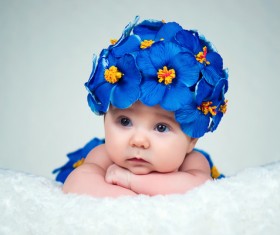 Baby wearing a flower hat Stock Photo