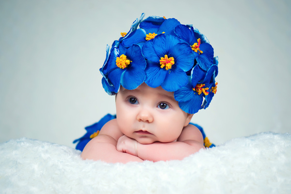Baby wearing a flower hat Stock Photo