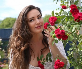 Beautiful woman smells of flowers Stock Photo