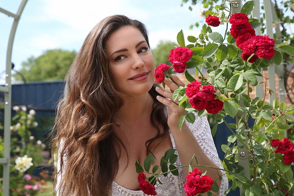 Beautiful woman smells of flowers Stock Photo