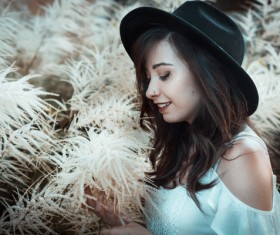 Beautiful young lady posing by wild flowers Stock Photo