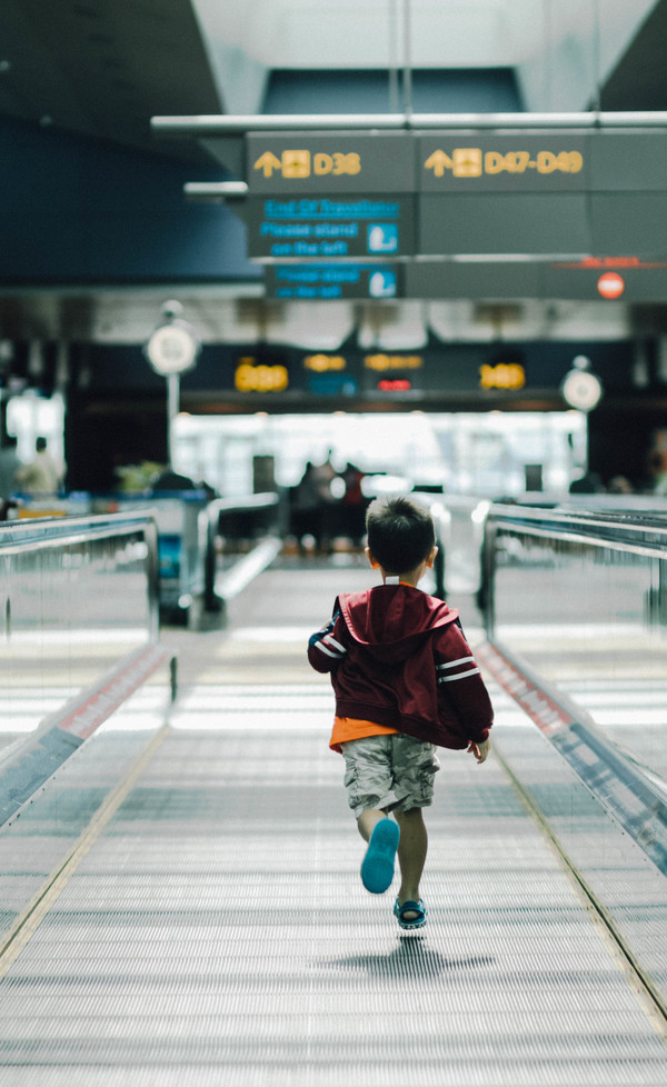 Boy running in airport Stock Photo