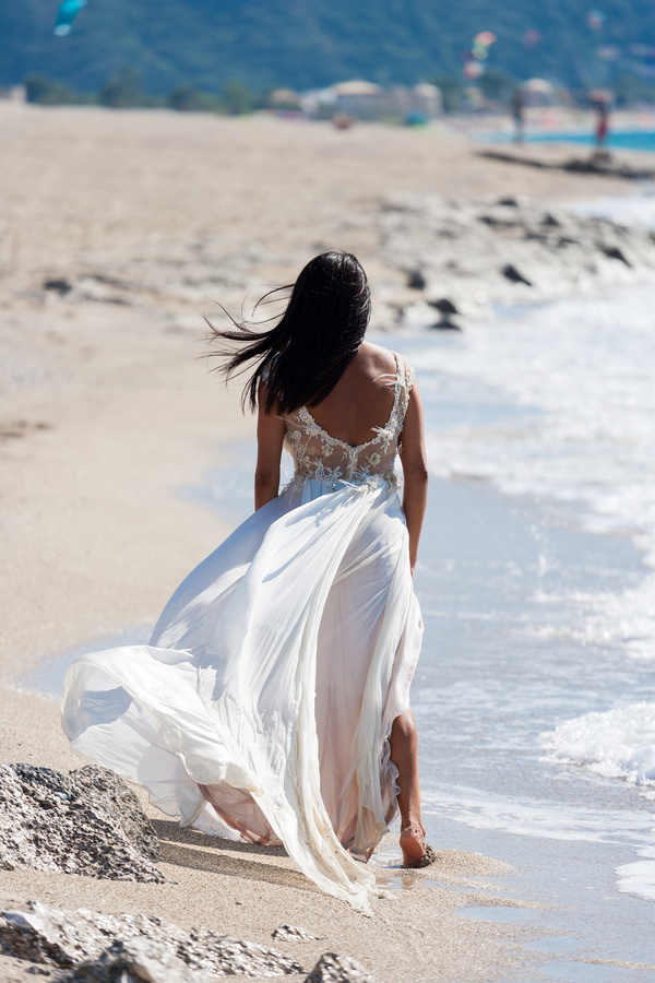Bride walking on the beach Stock Photo