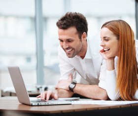 Business partners working on laptop Stock Photo 01