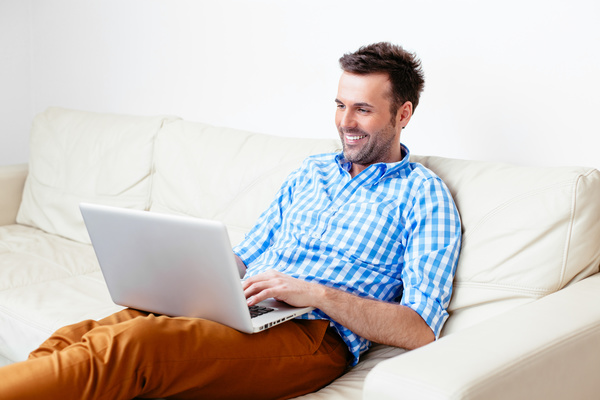 Casual man relaxing using laptop Stock Photo 02