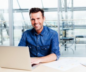 Casual man relaxing using laptop Stock Photo 03