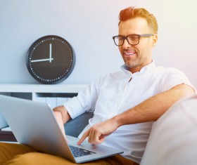 Casual man relaxing using laptop Stock Photo 04