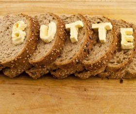 Cheese letters and slices of bread Stock Photo