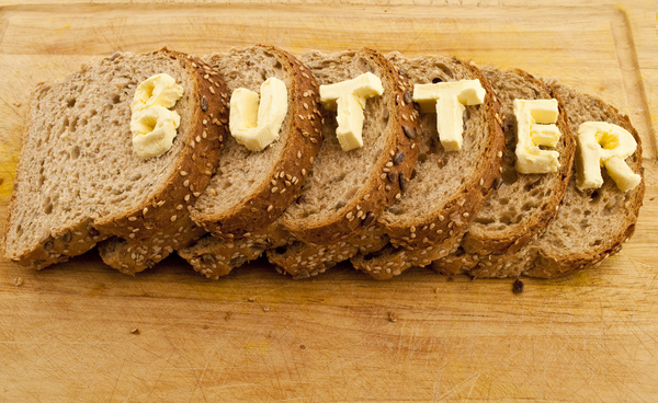 Cheese letters and slices of bread Stock Photo