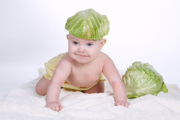 Cute baby and vegetables Stock Photo