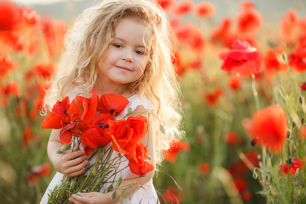 Cute little girl holding flowers Stock Photo