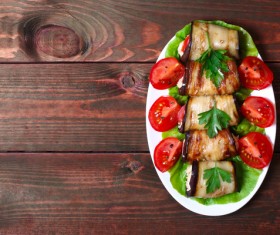 Eggplant meat rolls with tomatoes Stock Photo