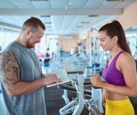 Fitness coach formulate fitness program Stock Photo