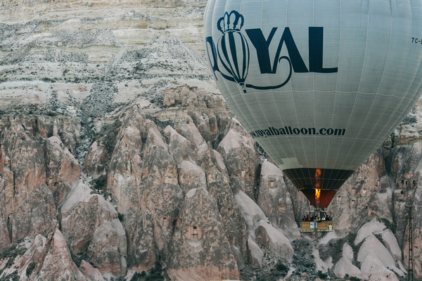 Flying hot balloon above rocky mountain landscape Stock Photo