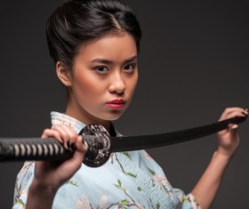 Girl holding samurai sword Stock Photo