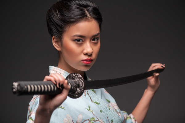 Girl holding samurai sword Stock Photo
