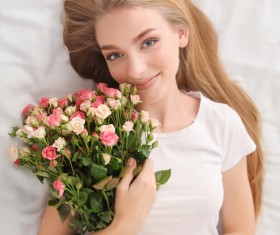 Girl in bed holding rose flower in bed Stock Photo 04