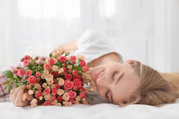 Girl in bed holding rose flower in bed Stock Photo 05