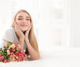 Girl in bed holding rose flower in bed Stock Photo 06