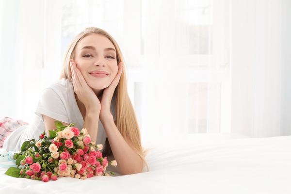 Girl in bed holding rose flower in bed Stock Photo 06