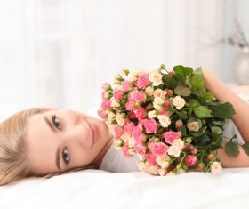 Girl in bed holding rose flower in bed Stock Photo 07