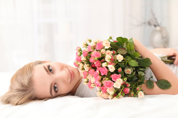 Girl in bed holding rose flower in bed Stock Photo 07