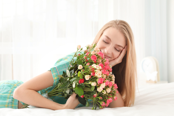 Girl in bed holding rose flower in bed Stock Photo 08