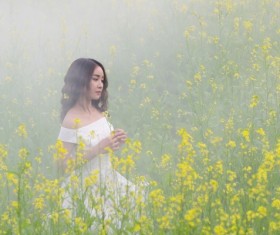 Girl standing in rape blossoms Stock Photo