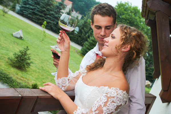 Happy wedding couple drinking wine Stock Photo