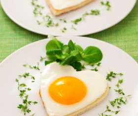Heart-shaped fried egg and bread breakfast Stock Photo 01