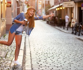 Hold instant coffee girl hail a taxi Stock Photo