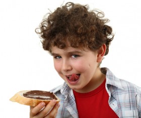 Little boy eating bread chocolate sauce Stock Photo