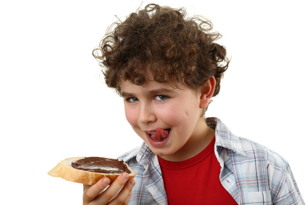Little boy eating bread chocolate sauce Stock Photo