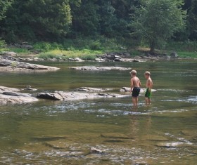 Little boy playing in the river Stock Photo