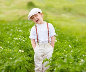 Little boy standing in farmland smiling Stock Photo
