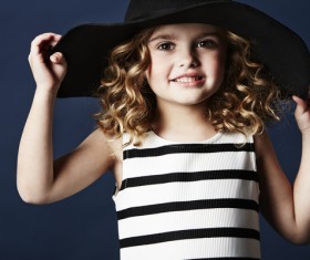 Little girl wearing a black hat Stock Photo