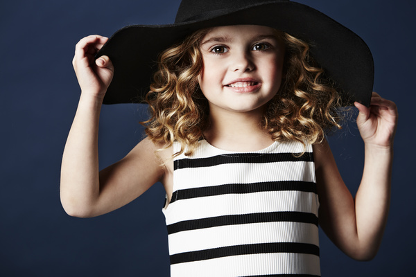 Little girl wearing a black hat Stock Photo
